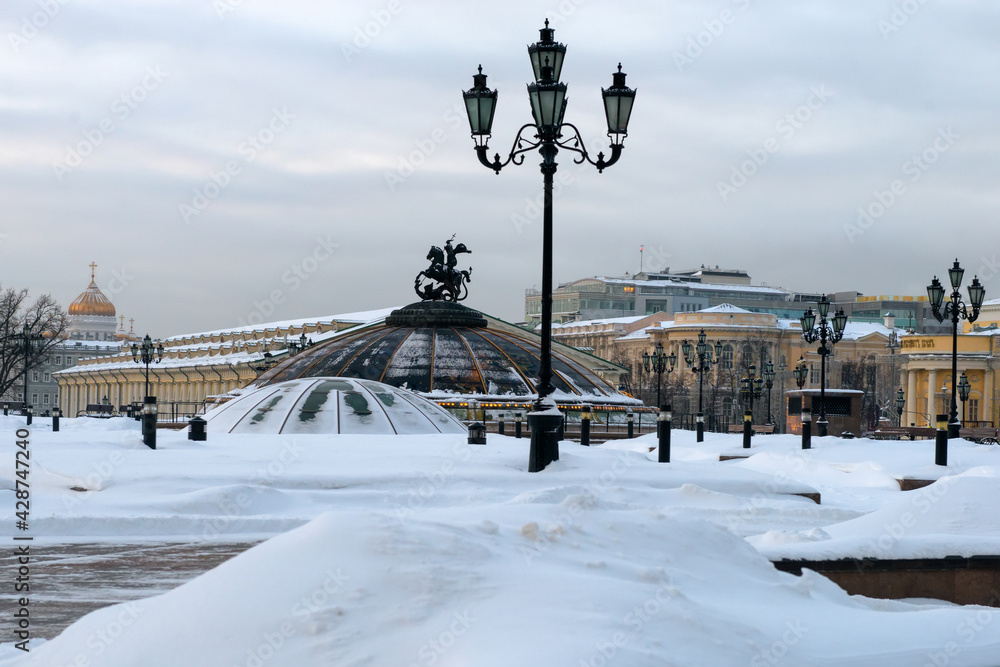 Manezhnaya (Manezhnaya) square in winter in Moscow, Russia. Panoramic beautiful view of the center of Moscow after a snowfall. Historical architecture and landscape of snowy Moscow.