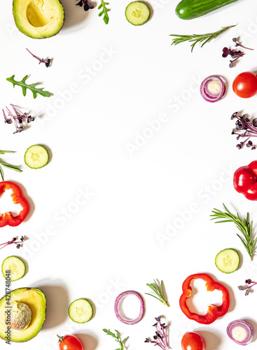 Creative layout of tomatoes, cucumbers, bell peppers, avocados and salads. flat lay. Food concept. place for your text