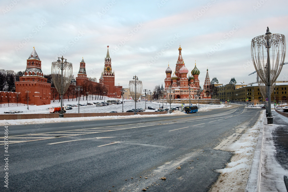 Fototapeta premium MOSCOW, View of Vasilievsky Spusk, Red Square, St. Basil's Cathedral and the Spasskaya Tower of the Moscow Kremlin on a frosty winter morning