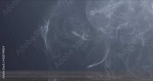 SUPER SLOW MOTION Empty pistol shells falling on a ground against blue background. Shot with high speed camera at 720 FPS