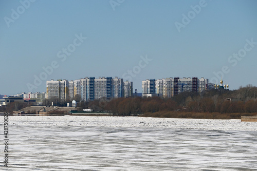 Spring ice on the river. Panorama is a city by the river. High quality photo