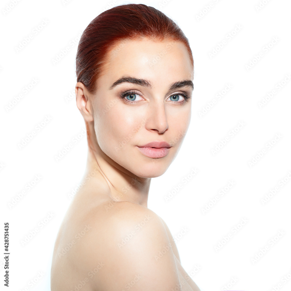 Fototapeta premium Portrait of beautiful woman with clean skin happy smiling and looking at camera over blue gray background, youth concept, beauty treatment. Beauty female face and shoulders