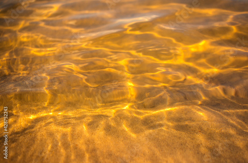 water texture with waves. sea waves with sun glare.