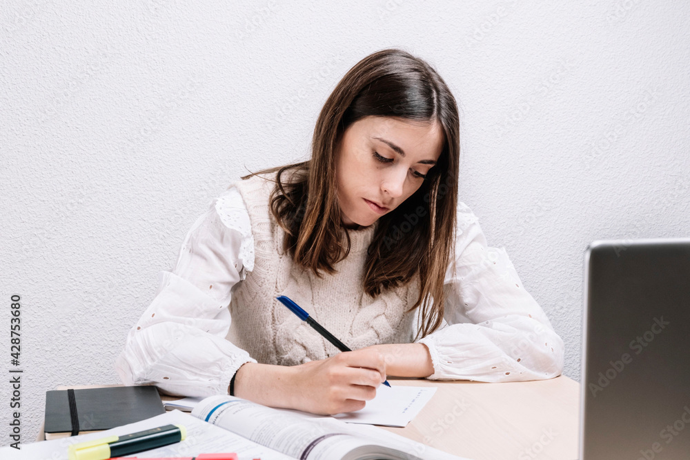 Young woman studying with notes at home. Entrepreneur concept. Young woman. Young woman studying with notes at home. Entrepreneur concept. Young woman.
