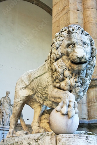 Florence  Tuscany  Italy  ancient statue of a lion in Piazza della Signoria  sculpture that depicts a lion with a sphere under one paw