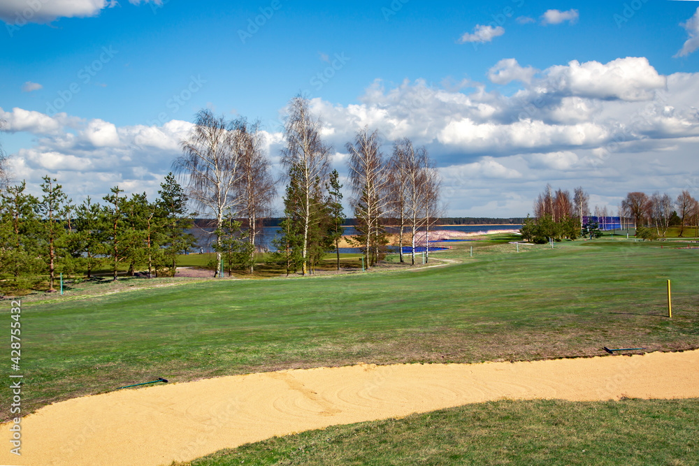 Obraz premium Golf place with gorgeous green and nice Kisezers lake view in Riga, Latvia