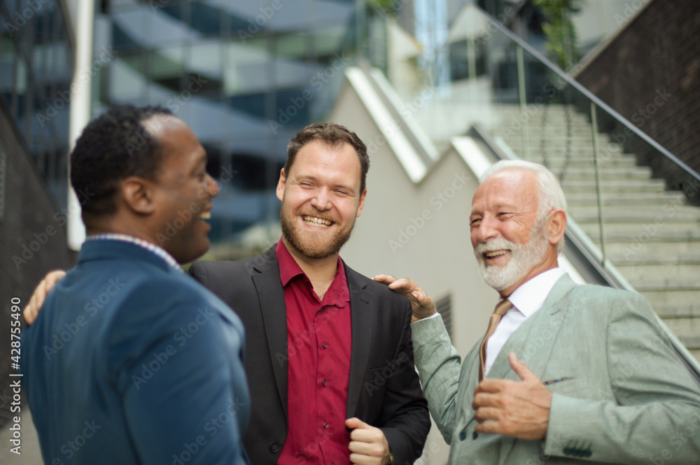 Perfect partnership. Three business men talking. Focus is on background. Perfect partnership. Three business men talking. Focus is on background.