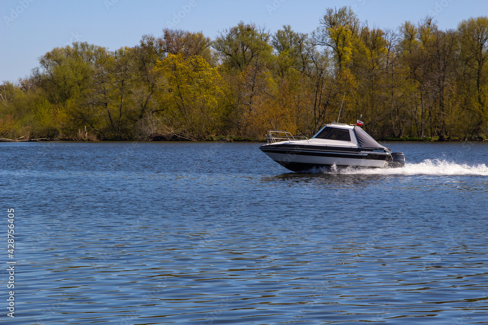 Fototapeta premium boat on the river, Speed boat, enjoying a motorboat ride down river