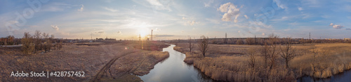 Panorama of river with power towers in background