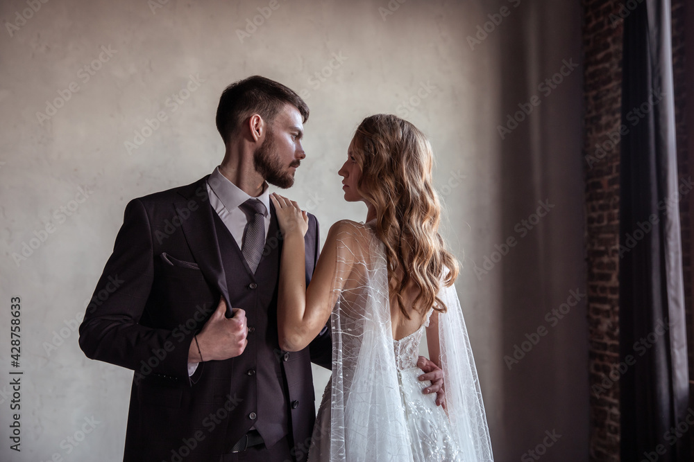 beautiful young couple. groom and bride. a modern wedding. dark interior