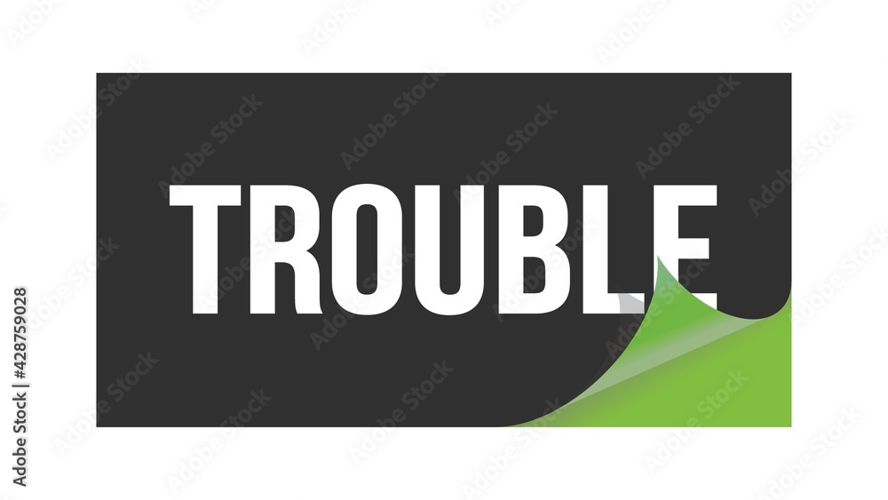 TROUBLE text written on black green sticker. TROUBLE text written on black green sticker.