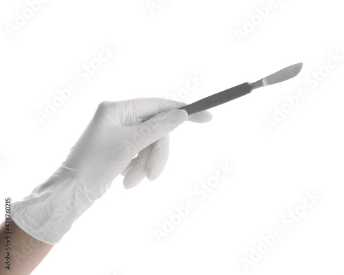 Doctor holding surgical scalpel on white background, closeup. Medical instrument