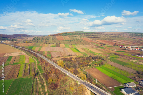 Aerial view of the countryside. Highway and farmlands near the village in autumn. Ukraine