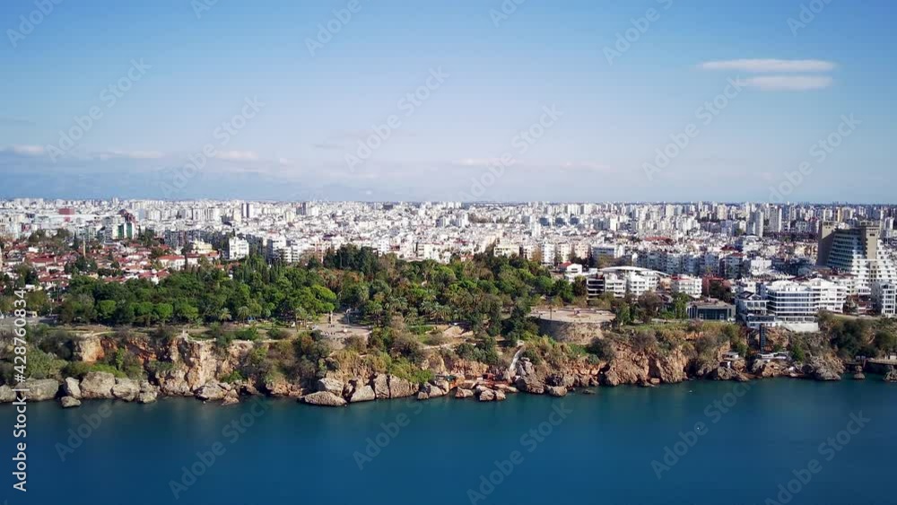Aerial photograph of Antalya bay in Antalya city from high point of drone fly on sunny day in Turkey. Amazing aerial cityscape view from birds fly altitude on beautiful town and sea full of yahts