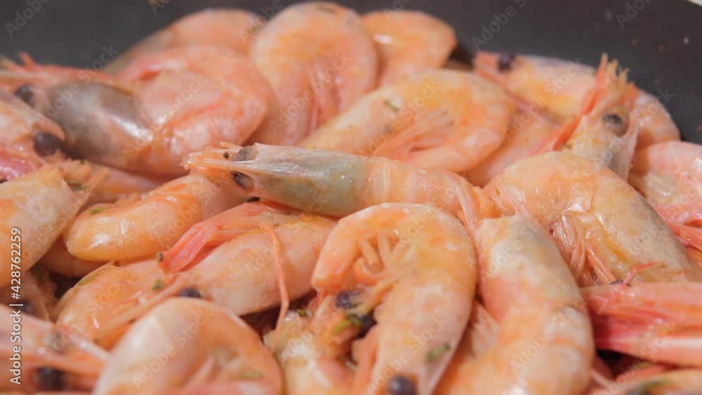 Shrimps with heads on the pan close-up in selective focus. sea food Shrimps with heads on the pan close-up in selective focus. sea food
