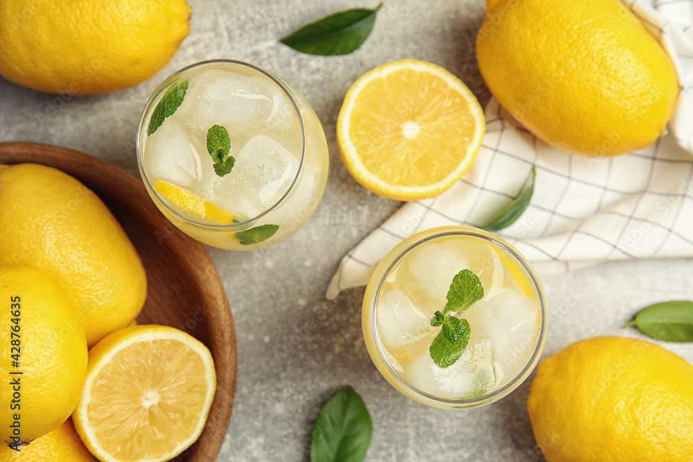 Cool freshly made lemonade and fruits on grey table, flat lay Cool freshly made lemonade and fruits on grey table, flat lay