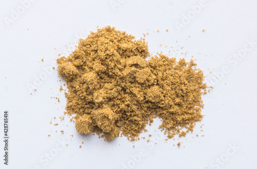 Powder of cumin on a white base.  photo