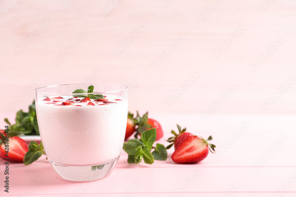 Delicious drink with strawberries on pink table, space for text Delicious drink with strawberries on pink table, space for text
