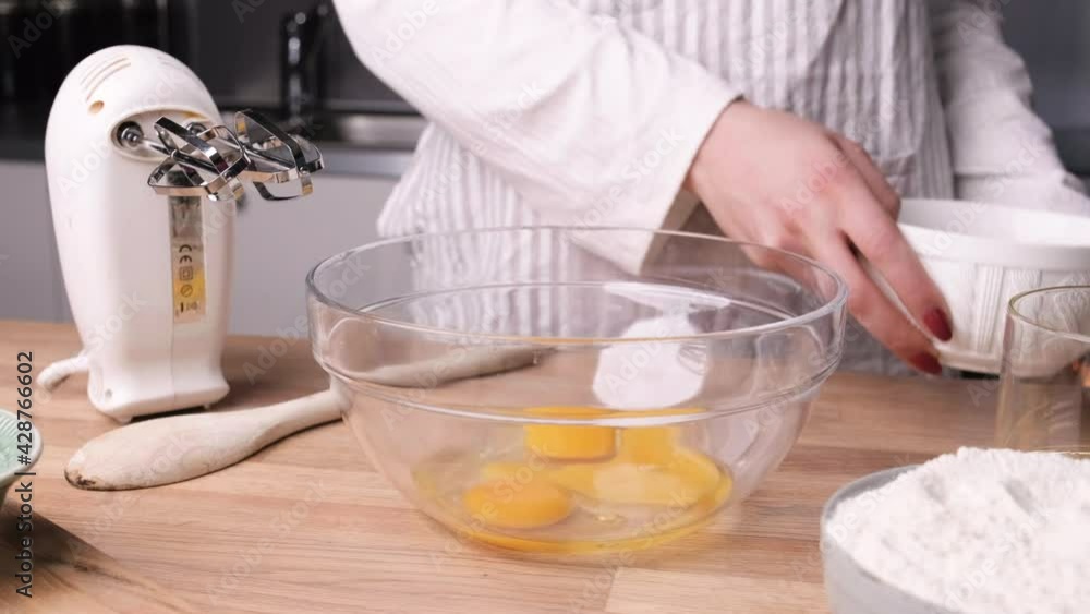 Woman Pouring Eggs and Sugar into Glass Bowl. - Slider Right Woman Pouring Eggs and Sugar into Glass Bowl. - Slider Right