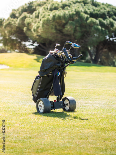 A vertical shot of a golf bag trolley on a professional golf course