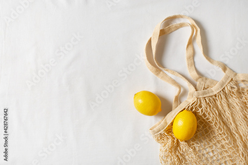 Zero waste concept with string bag, mesh bag, grosery bag with lemon on white background