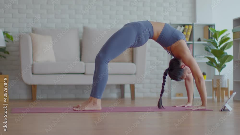 Wellness Attractive Asian woman look laptop practice yoga bridge online course at home to meditation comfortable and relax,Health care and Exercise at home Concept,Self-isolation due COVID-19 pandemic Wellness Attractive Asian woman look laptop practice yoga bridge online course at home to meditation comfortable and relax,Health care and Exercise at home Concept,Self-isolation due COVID-19 pandemic