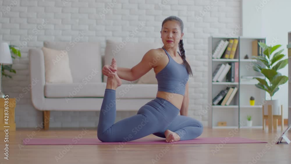 Attractive Asian woman practice yoga king pigeon pose online course at home to meditation comfortable and relax,Health care and Exercise at home Concept,Self-isolation due COVID-19 pandemic Attractive Asian woman practice yoga king pigeon pose online course at home to meditation comfortable and relax,Health care and Exercise at home Concept,Self-isolation due COVID-19 pandemic