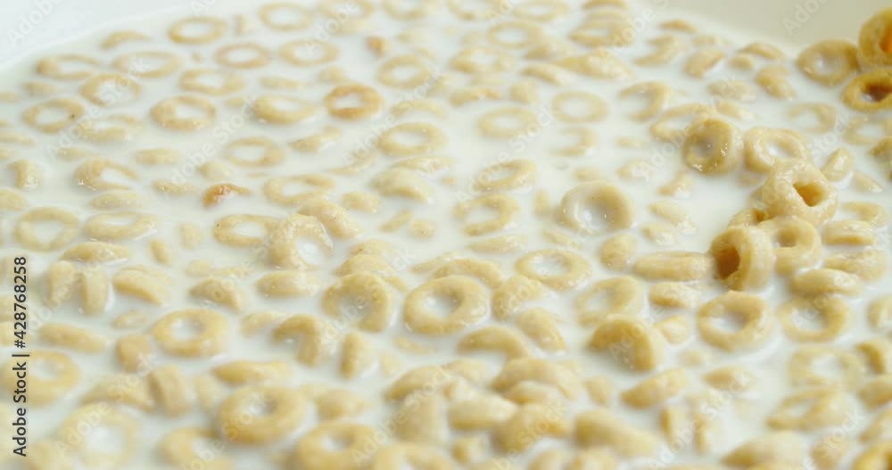 Nutritious healthy breakfast with oatmeal in a bowl of milk, spoon dials breakfast from the plate slow motion, close-up. 4K resolution. Nutritious healthy breakfast with oatmeal in a bowl of milk, spoon dials breakfast from the plate slow motion, close-up. 4K resolution.