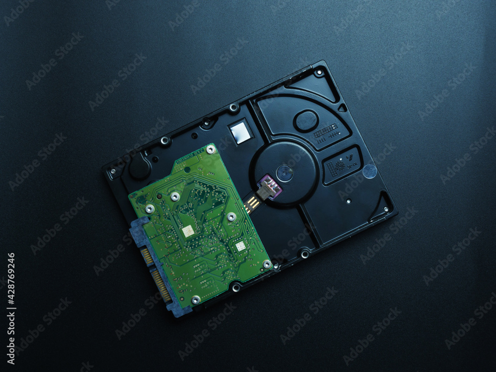 Opened hard drive disk on dark background. Opened hard drive disk on dark background.