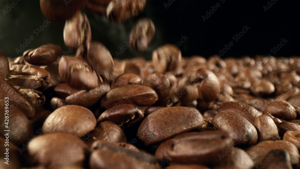 Falling roasted coffee beans Falling roasted coffee beans