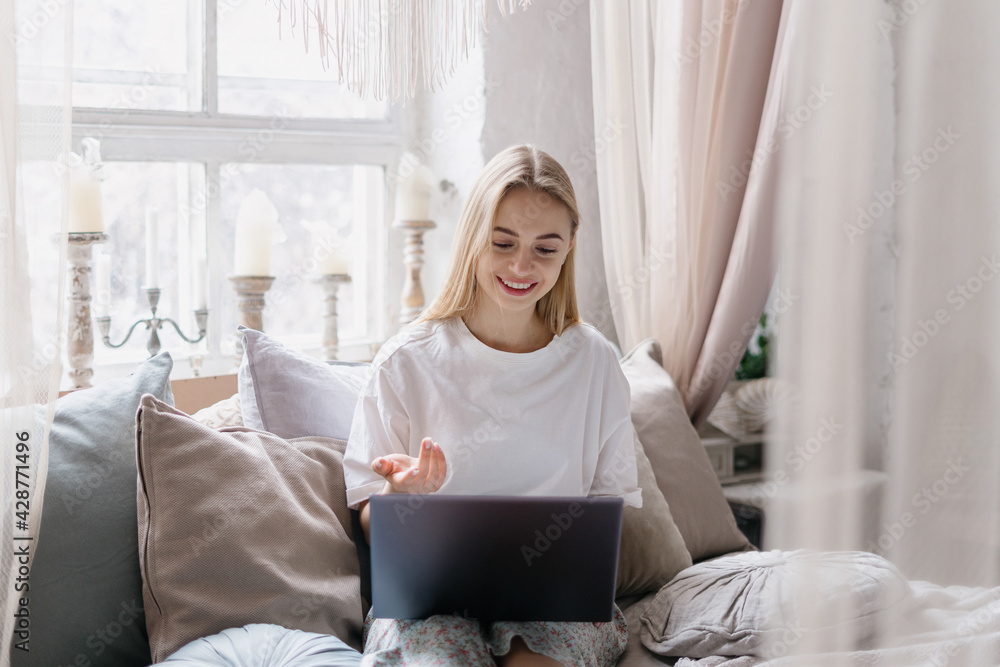 Young woman using modern laptop, talking at video call Young woman using modern laptop, talking at video call