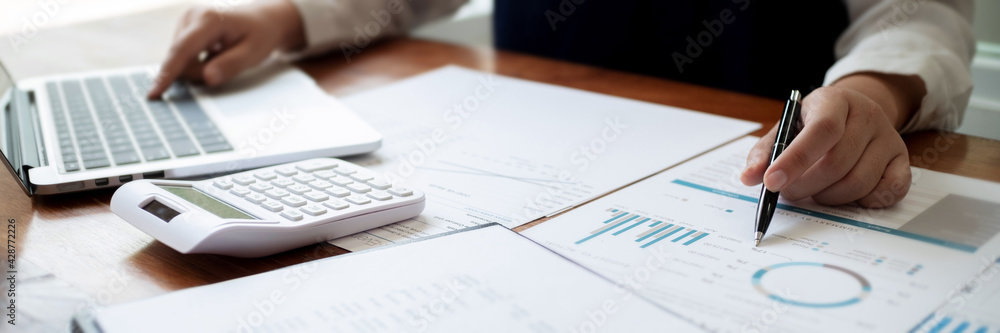 Financial inspector calculating a numbers in office room.. Financial inspector calculating a numbers in office room..