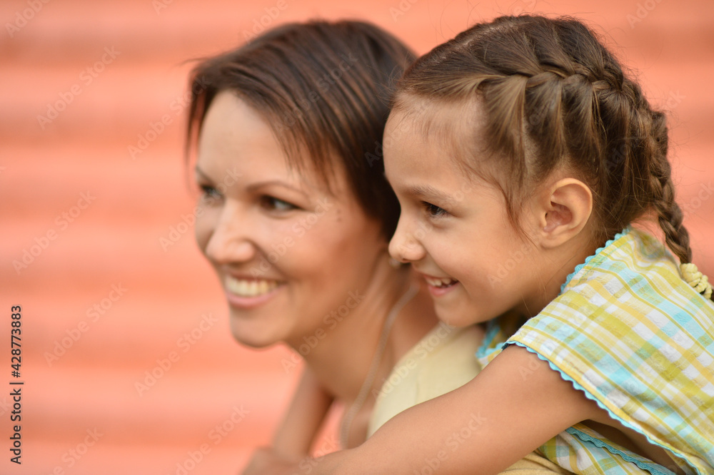 Portrait of happy mother and daughter posing outdoors Portrait of happy mother and daughter posing outdoors