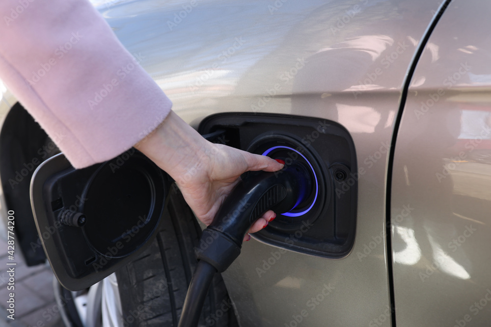 Woman hand holding charger for car closeup Woman hand holding charger for car closeup