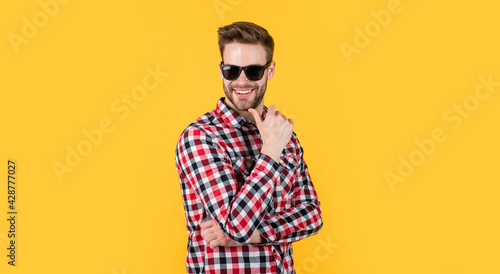 stylish guy with trendy hairstyle wear checkered shirt and glasses, wardrobe