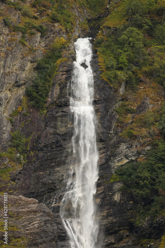 waterfall at fjord rock wall