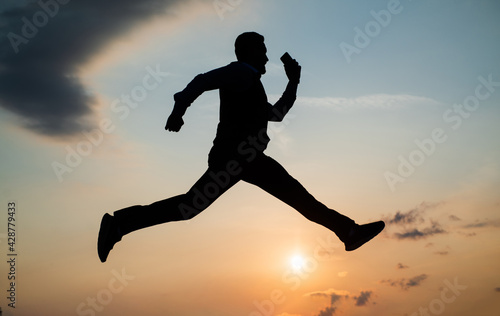 total freedom. personal achievement goal. man silhouette jump on sky background. confident businessman running. daily motivation. enjoying life and nature. business success. freedom