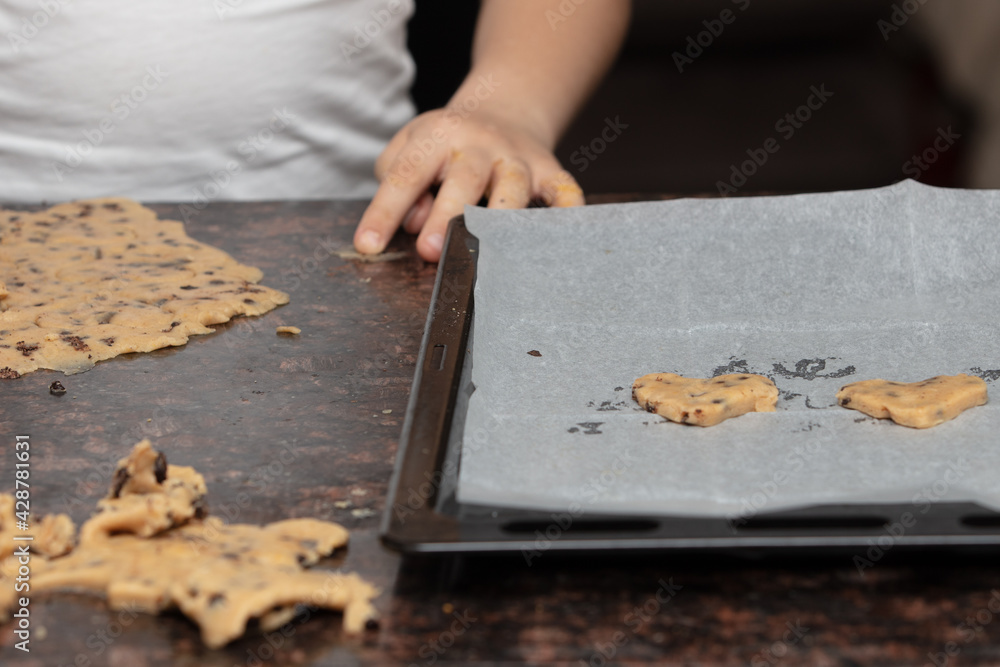 Kids baking cookies in house kitchen . Close up child hands preparing cookies using cookie. Kids baking cookies in house kitchen . Close up child hands preparing cookies using cookie.