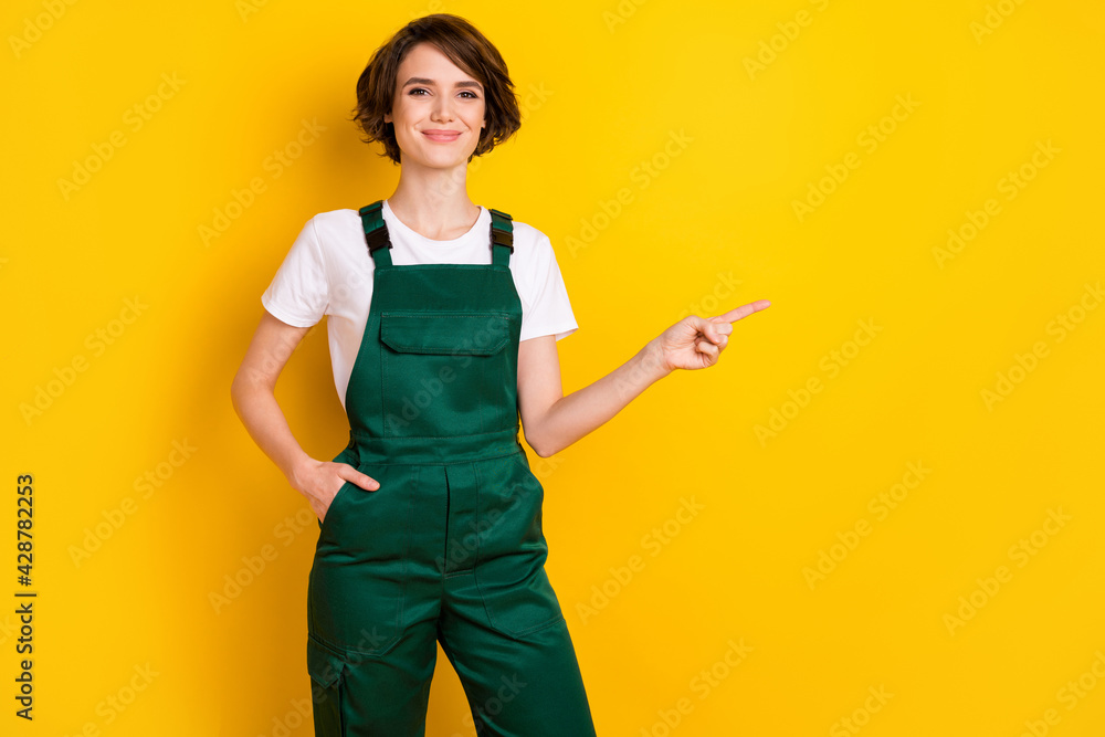 Photo of pretty person arm in pocket indicate finger empty space proposition isolated on yellow color background Photo of pretty person arm in pocket indicate finger empty space proposition isolated on yellow color background