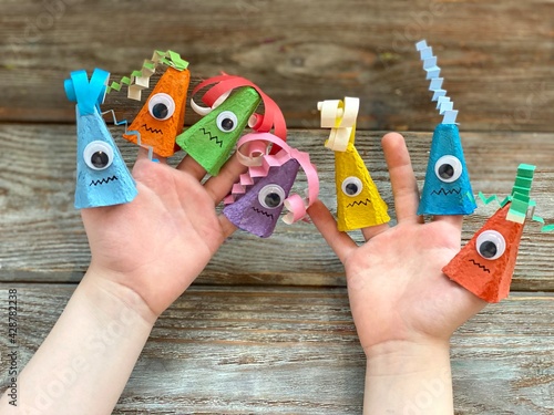 Billede på lærred Cute monsters on children's hand, kids DIY from recycling egg box