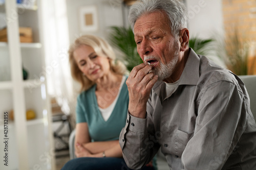 Senior man having a problem. Wife comforting her sad husband..