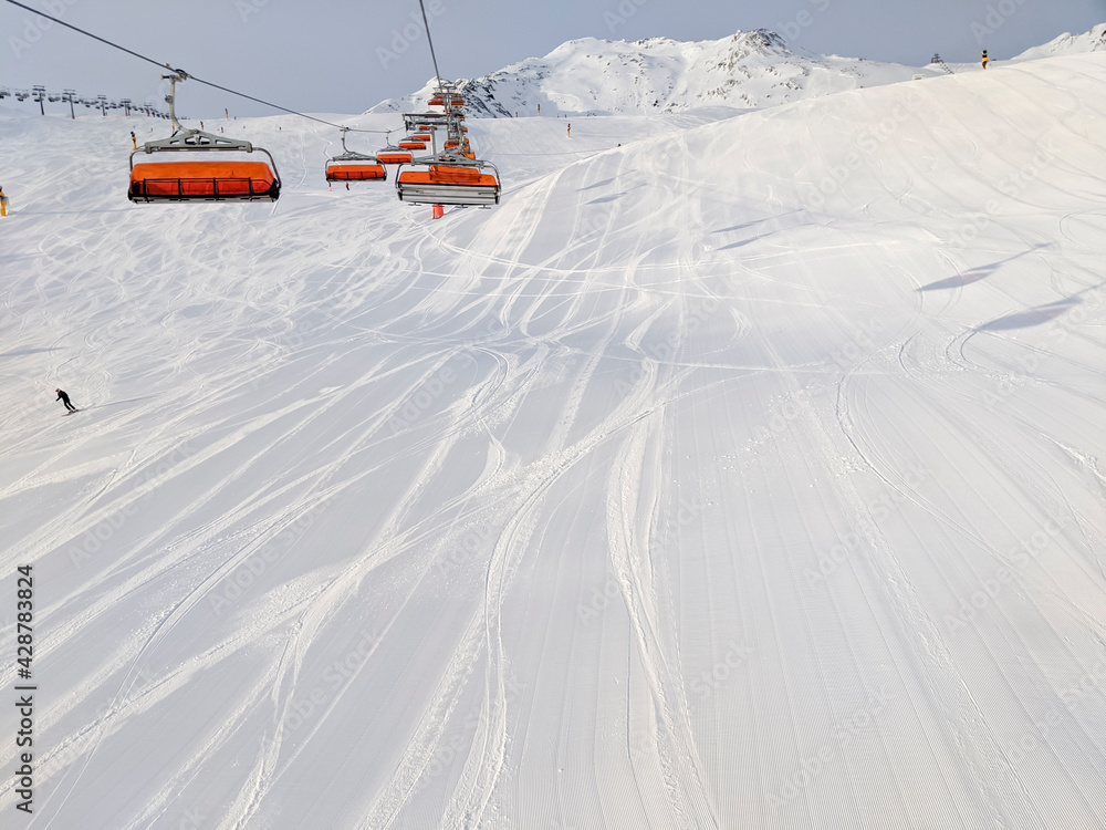 Soelden, Austria - December 24 2019: Chairlift above a ski slope, on a sunny winter day Soelden, Austria - December 24 2019: Chairlift above a ski slope, on a sunny winter day