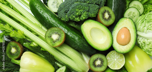 Fotografía Fresh green vegetables on whole background, close up