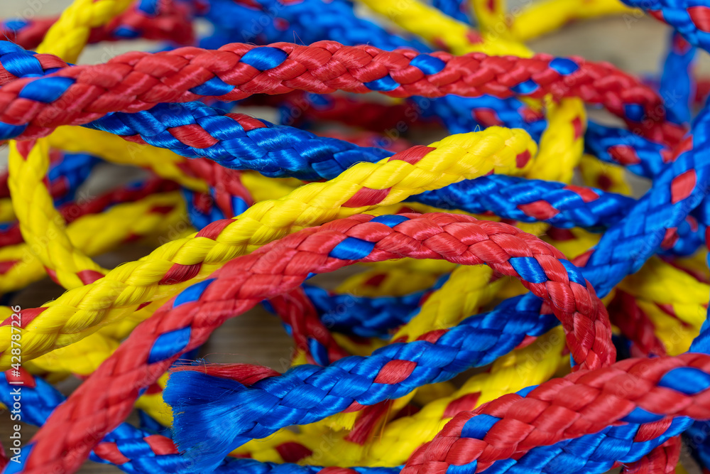 random arrangement of red, blue and yellow nautical cables in synthetic material, close up