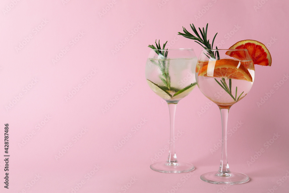 Glasses of cocktails with citrus on pink background Glasses of cocktails with citrus on pink background