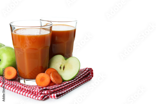 Glasses of juice and ingredients on towel isolated on white background