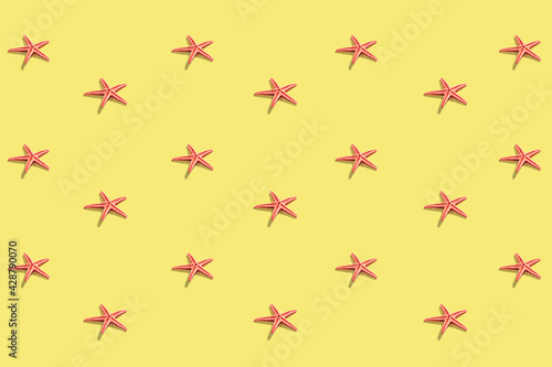 Starfish pattern on the pastel yellow background