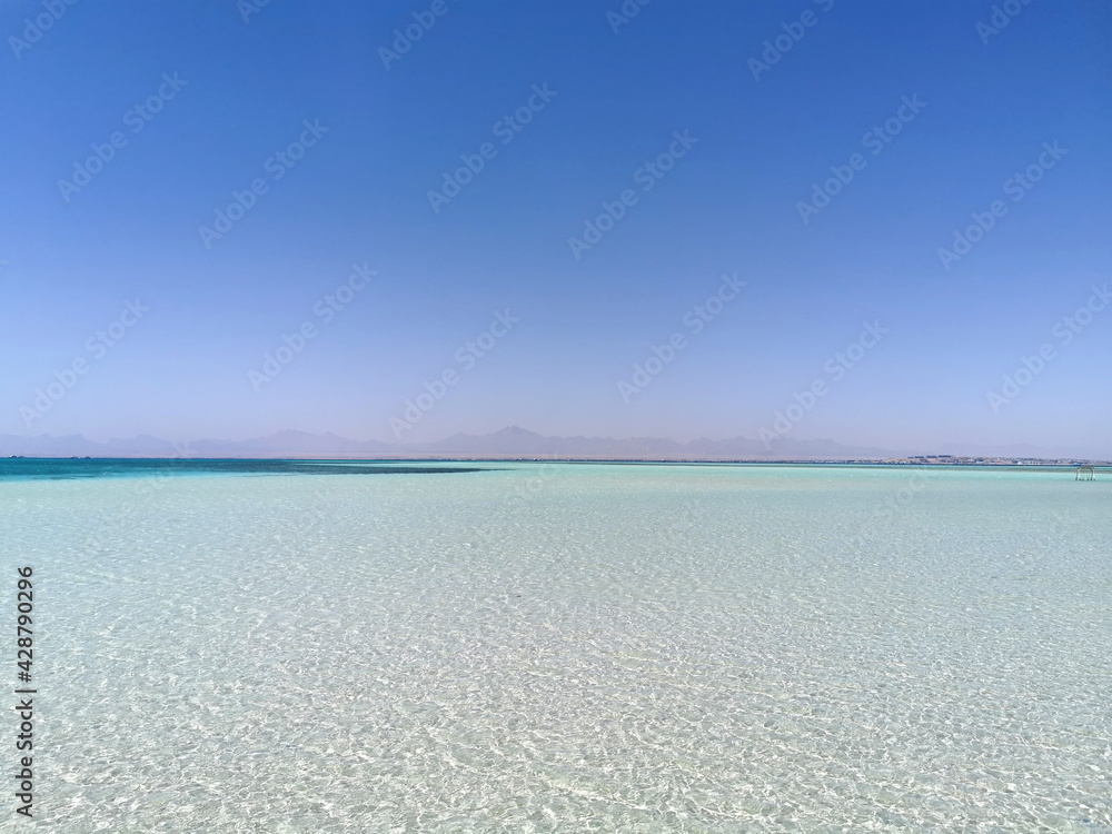 Beautiful background with still sea water near the coral. Calm and relaxed picture taken on sunny day in tropical country near the beach of the sea