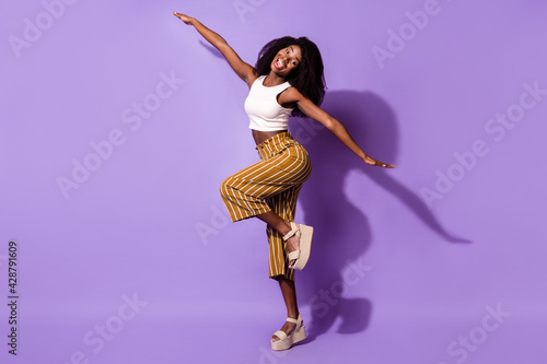 Full length body size view of attractive funny cheerful girl having fun like plane isolated over bright violet purple color background