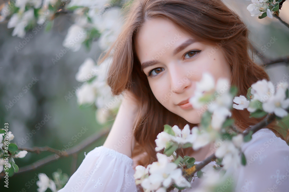 springtime fashion portrait of a young girl in a blooming cherry garden, tenderness of the morning springtime fashion portrait of a young girl in a blooming cherry garden, tenderness of the morning